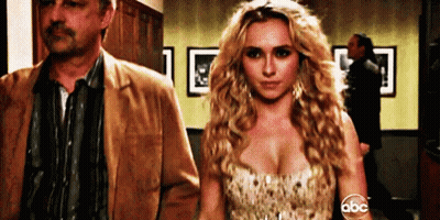Woman In Dress Next To Man In Jacket GIF