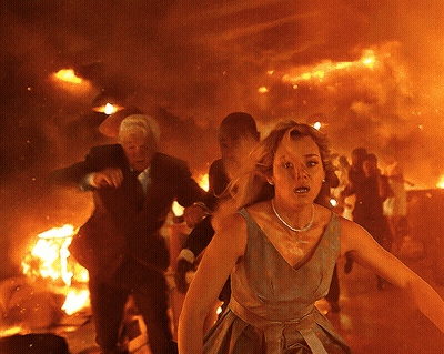 Woman In Dress Running From Burning Building GIF