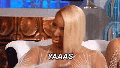 Woman In Dress Sitting In Living Room GIF