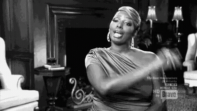 Woman In Dress Sitting In Living Room GIF