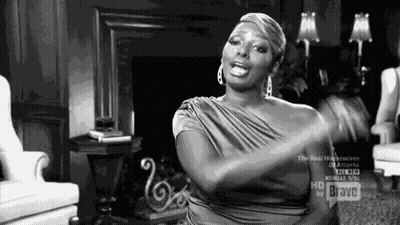 Woman In Dress Sitting With Hands In Air GIF