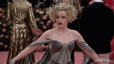 Woman In Dress With Crown On Pink Carpet GIF