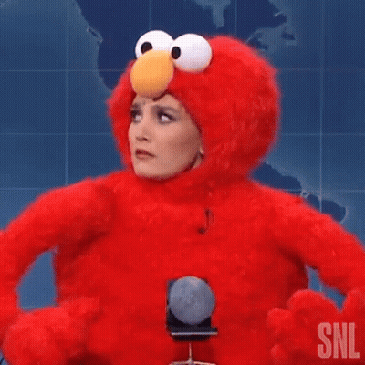 Woman In Elmo Costume Holding Microphone Making Funny Face GIF