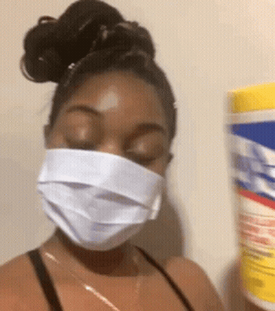 Woman In Face Mask Holding Bucket Of Tissues GIF