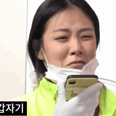 Woman In Face Mask Holding Cell Phone GIF