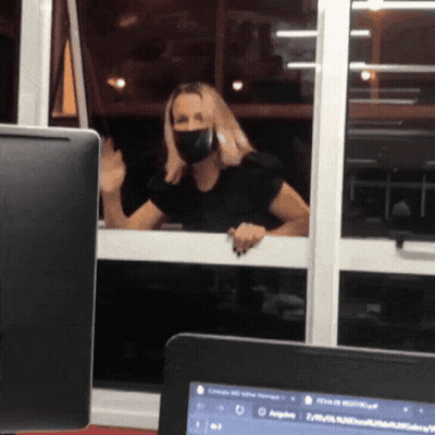 Woman In Face Mask Looking Out Window GIF