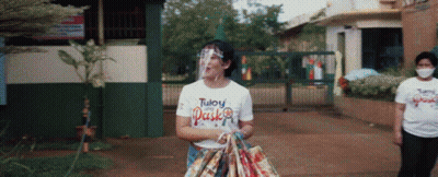 Woman In Face Shield And White Tuloy Pasko Shirt GIF