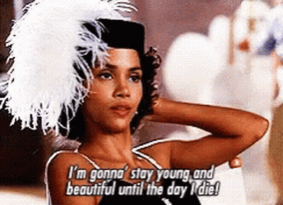 Woman in Feathered Hat Saying I'm Gonna Stay Young and Beautiful Until the Day I Die