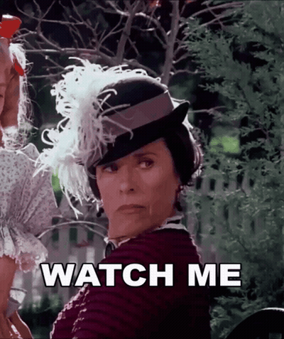 Woman In Feathered Hat Saying Watch Me GIF
