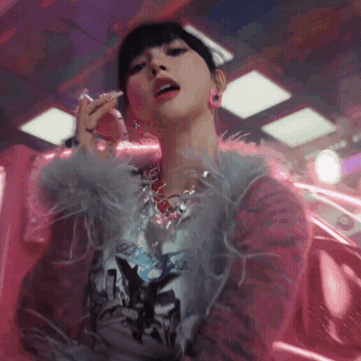 Woman In Feathered Jacket And Necklace Smoking Cigarette GIF