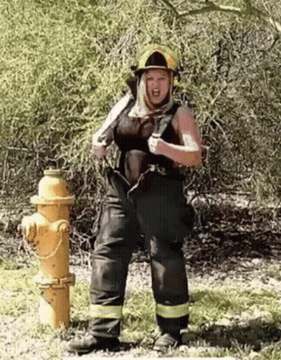 Woman in Firefighter Costume Next to Fire Hydrant