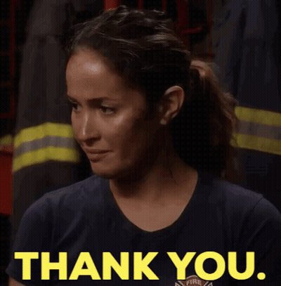 Woman In Firefighter Uniform Giving Thank You Sign GIF