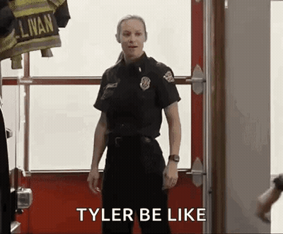 Woman In Firefighter Uniform In Front Of Fire Truck GIF