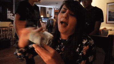 Woman in Floral Dress Holding Money