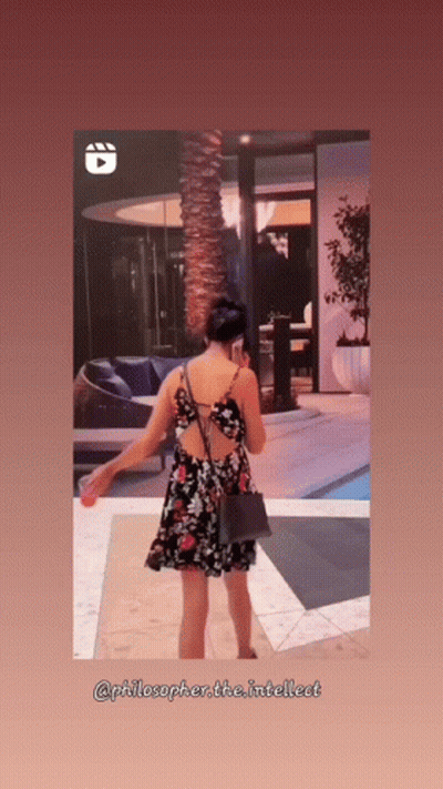 Woman In Floral Dress In Front Of Building GIF