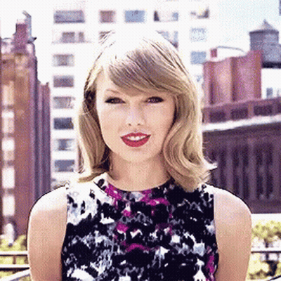 Woman In Floral Dress In Front Of City Skyline GIF