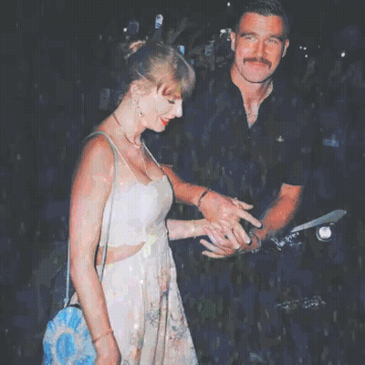 Woman In Floral Dress Next To Man In Black Shirt GIF