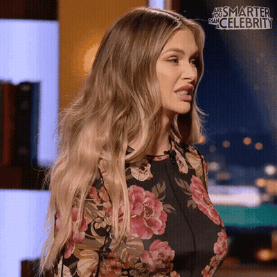 Woman In Floral Dress Smarter Than Celebrity Sign GIF