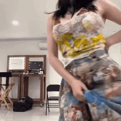 Woman In Floral Dress Taking Off Skirt GIF