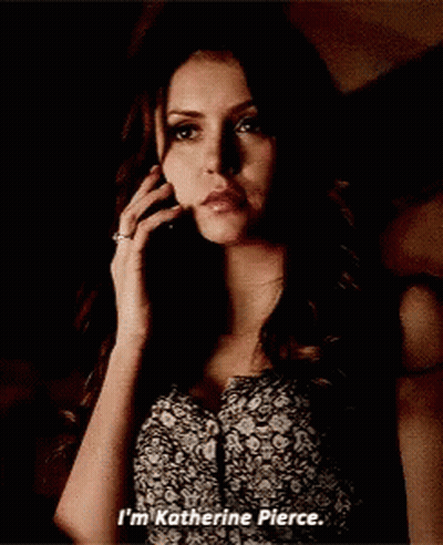 Woman In Floral Dress Talking On Cell Phone Says I'm Katherine Pierce GIF