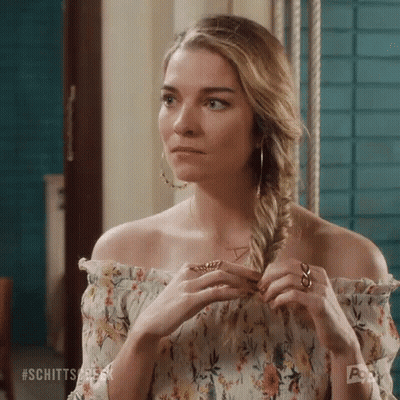 Woman In Floral Off-Shoulder Top Braiding Hair GIF
