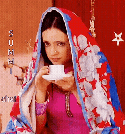 Woman In Floral Scarf Drinking Tea GIF