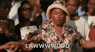 Woman In Floral Shirt And Hat Standing In Crowd GIF