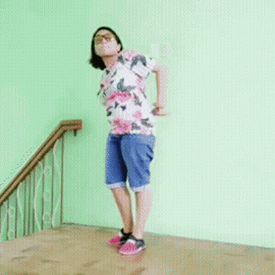 Woman In Floral Shirt Doing Handstand GIF