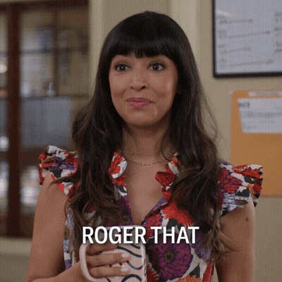 Woman In Floral Shirt Holding Mug Saying Roger That GIF