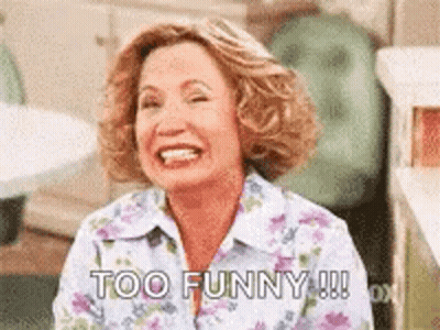 Woman In Floral Shirt Laughing Saying Too Funny GIF