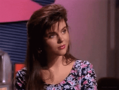 Woman In Floral Shirt Looking At Camera GIF