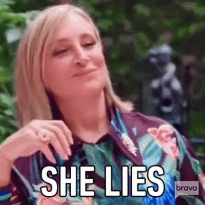 Woman In Floral Shirt Making Funny Face Saying She Lies GIF