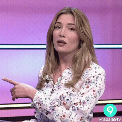 Woman In Floral Shirt Pointing Right GIF