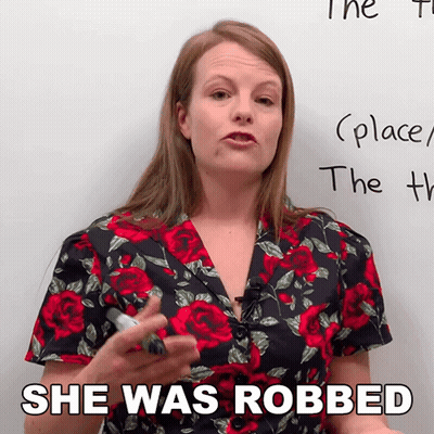 Woman In Floral Shirt Says She Was Robbed In Front Of Whiteboard GIF