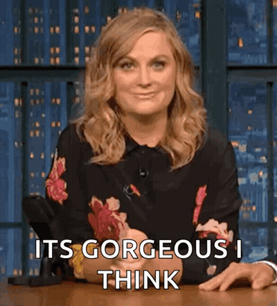 Woman In Floral Shirt Sitting At Table GIF