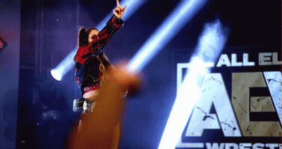 Woman In Front Of All Elite Wrestling Sign GIF