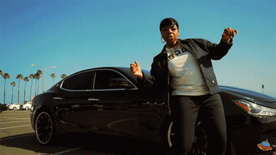Woman In Front Of Black Car With Number 24 On Sweatshirt GIF
