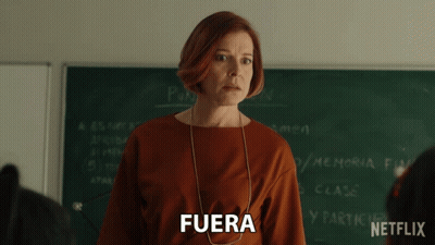 Woman In Front Of Blackboard With Fuera GIF