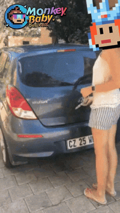 Woman In Front Of Blue Car With Monkey Baby GIF