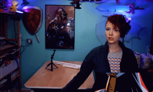 Woman In Front Of Blue Wall With Painting GIF