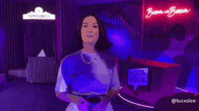 Woman In Front Of Boca Boca Sign GIF