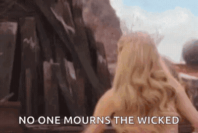Woman In Front Of Building Saying No One Mourns The Wicked GIF
