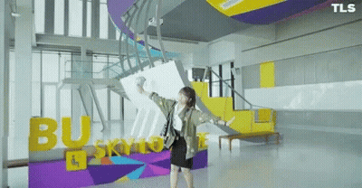 Woman In Front Of Busy Skyline Sign GIF