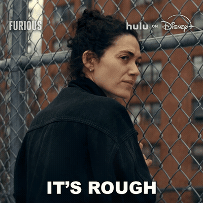 Woman In Front Of Chain Link Fence Saying It's Rough On The Bottom GIF