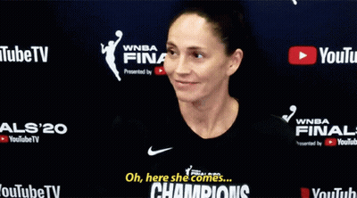 Woman In Front Of Champions Sign GIF