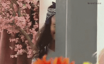 Woman In Front Of Cherry Blossom Tree Looking Out Window GIF