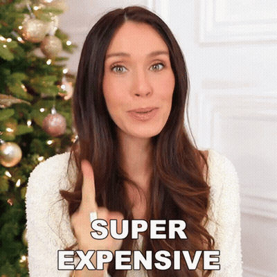 Woman In Front Of Christmas Tree Saying Super Expensive GIF