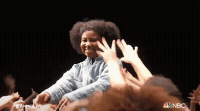 Woman In Front Of Crowd With NBC Logo GIF