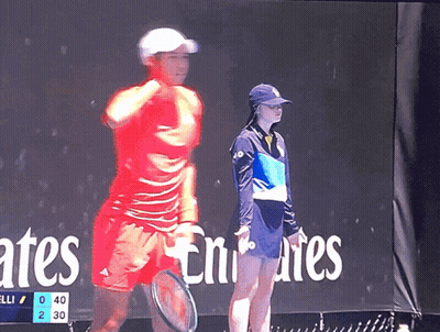 Woman In Front Of Emirates Sign GIF