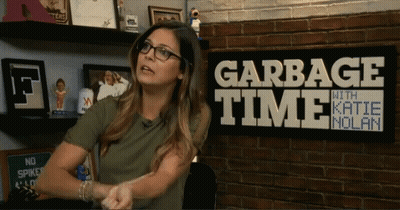 Woman In Front Of Garbage Time With Katie Molan Sign GIF